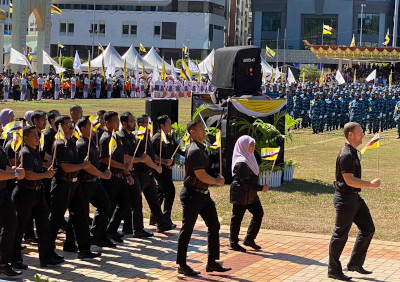On Brunei National Day: Matt leading the march past the Sultan and dignitaries with sports school staff and students